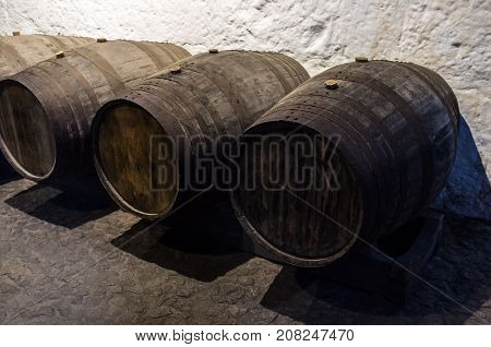 Old wooden barrels for wine in wine cellar, Wine symbol, Old barric wine barrels