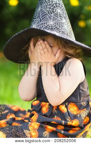 Little Girl Witch In Black Pointed Hat, Afraid Of Halloween