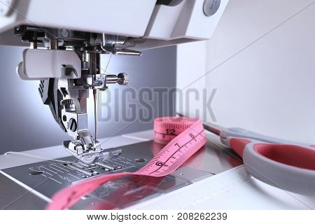 Sewing machine close up. Sewing machine foot and sewing accessories.