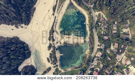 Aerial view of crystal clear lake surrounded with town. Jasna near Kranjska Gora, Slovenia.