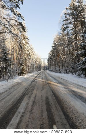 The Asphalt Part Of The Road Under Snow After Snowfall. The Sky In The Center Of The Frame