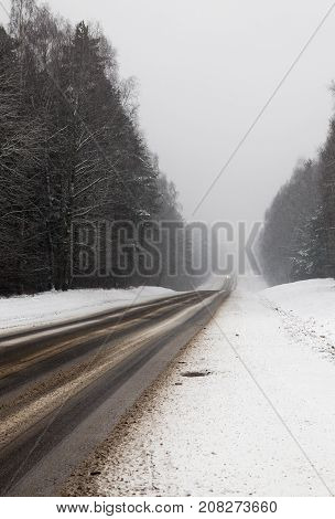 Dirty Snow, Which Printed Traces Of Transport On The Road. Photo Taken In The Winter Season At An An