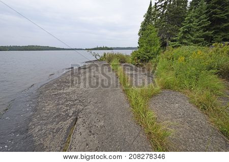 Ancient Rocks on a Wilderness Lake Shore on Tuscarora Lake in the Boundary Waters in Minnesota