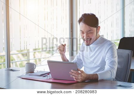 Young happy businessman with really impressive achievements victory Dance fast growing company rewarded successful deal positive news on stock screaming with happiness.