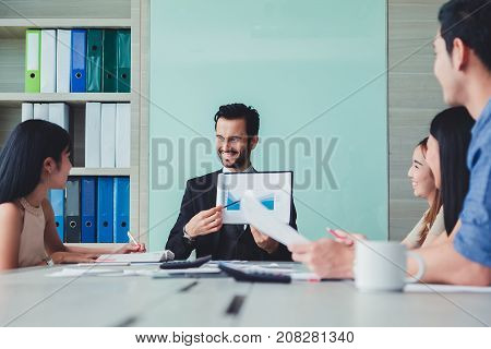 Manager holding papers hands and Smiling Professional team of coworlcers making great business discussion in modern office teamwork people.