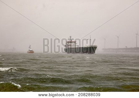 Industrial ship headig in heavy rian and storm