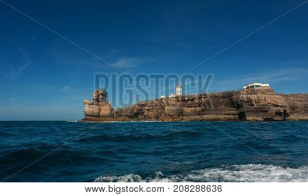 Nau dos Corvos and the Lighthouse of Peniche, Portugal. View from the ocean