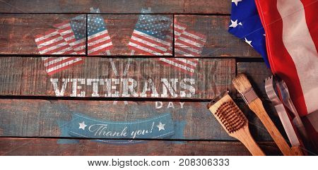 Logo for veterans day in america  against basting brush and tong with american flag on table