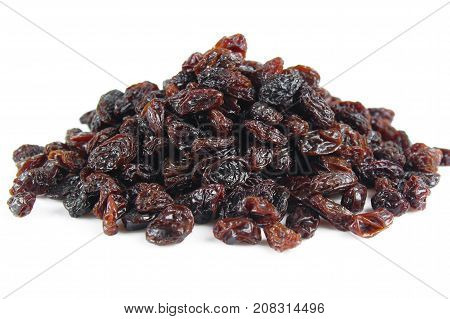 black raisins isolated on white and wooden background