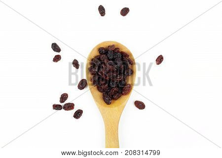 black raisins isolated on white and wooden background