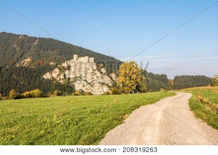 Ruins Of Strecno Castle In Autumn Landscape With Dirt Road