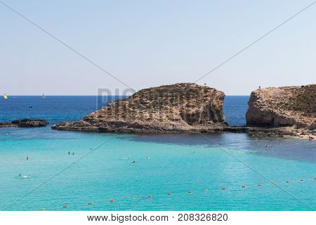 Stunning tropical Mediterranean sea, crystal clear azure turquoise blue waters of the Blue Lagoon on the small holiday destination island of Comino, Malta, June 2017