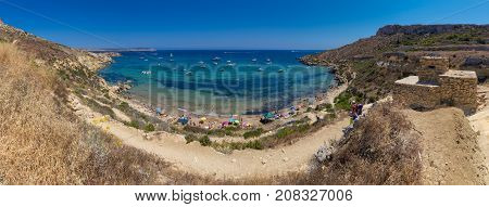 Ultra high resolution panorama of beautiful azure blue water of Selmun beach in the summer time, in Maltese Imgiebah Bay, Il-Mellieha, Malta, June 2017