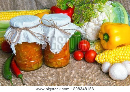 jars with winter supplies, banks with salad are on the table with vegetables