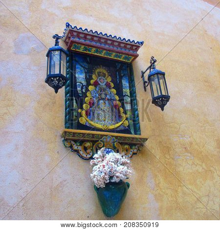 a religious fresquo in the streets of seville ( spain )