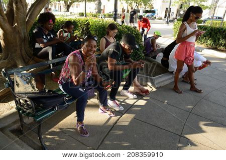 CIENFUEGOS CUBA - 06 NOVEMBER 2016: Cubans using the available Internet on the main square in cities on Cuba