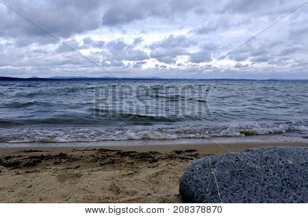 evening lake in cloudy weather, South Ural, Uvildy, in the distance are seen the Ural mountains
