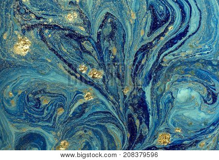 Marbled blue abstract background with golden sequins. Liquid marble ink pattern