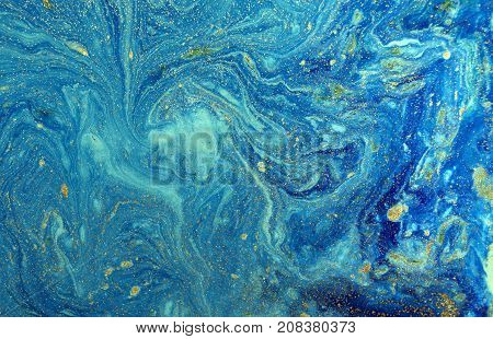 Marbled blue abstract background with golden sequins. Liquid marble ink pattern