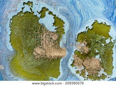 Marbled blue abstract background with golden sequins. Liquid marble ink pattern