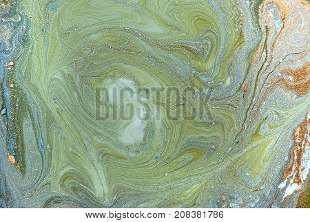 Marbled blue abstract background with golden sequins. Liquid marble ink pattern