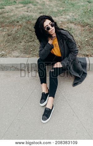 Portrait Of Stylish Modern Young Curly Woman In Coat Sunglasses
