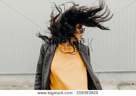 Portrait Of Stylish Modern Young Curly Woman In Coat Sunglasses