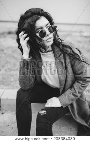 Portrait Of Stylish Modern Young Curly Woman In Coat Sunglasses