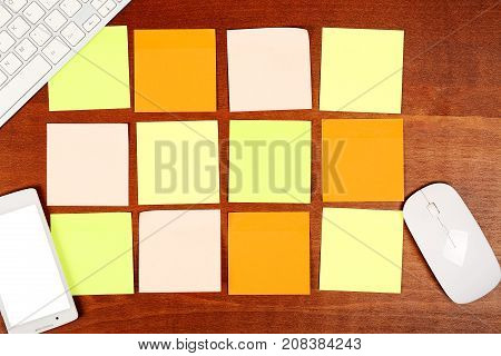 top view of modern desk with twelve colorful adhesive notes