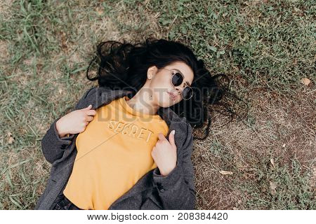 Portrait Of Stylish Modern Young Curly Woman In Coat Sunglasses