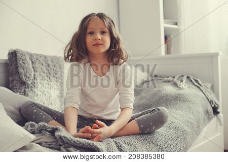happy kid girl walking up in early morning in her room