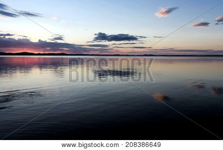 evening colorful cloudy sky over the lake, South Ural, Uvildy