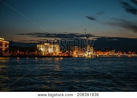 Night cityscape, river and Avrora or Aurora in St. Petersburg, Russia