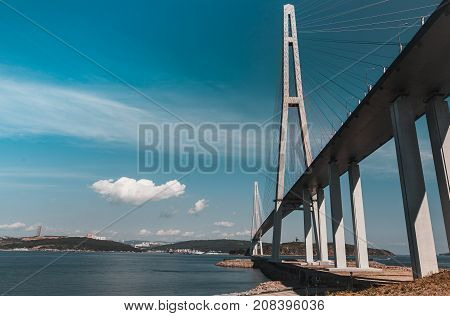 The long handsome cable-stayed bridge on the island is Russian. Beautiful background