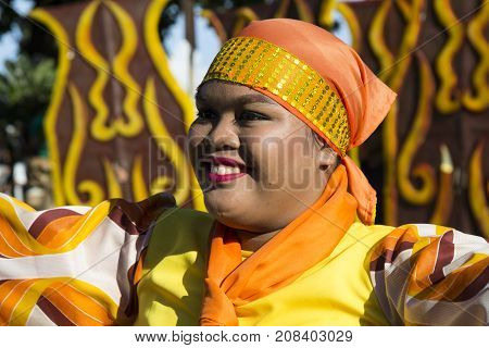 16 Sep 2017 Dumaguete Philippines - Smiling girl in national dress participating in street parade. Sandurot festival actor in traditional clothes. Philippines parade. Woman in native dress