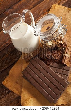 Chocolate Bars, Cinnamon Sticks, Nuts And Jug Of Milk
