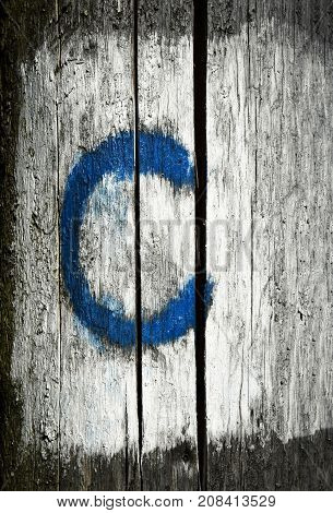 the blue letter c on a wooden background