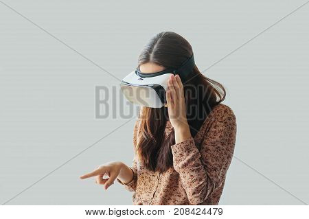 Young woman with virtual reality glasses. The concept of future technology. The concept of a remote study.
