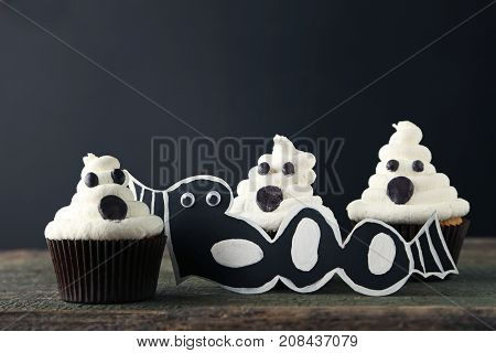 Sweet Halloween Cupcakes On The Wooden Table