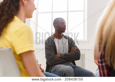 Meeting of support group. African-american man therapist listening to other people. Mental health, psychotherapy concept