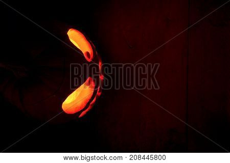 The Concept Of Halloween. The Ghastly, Ghastly Pumpkin Glows With A Fiery Yellow Light. Mystical Jac