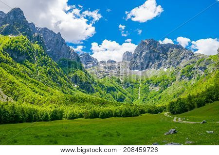 Picturesque Meadows And Forests Are Located Among The High Mountains.