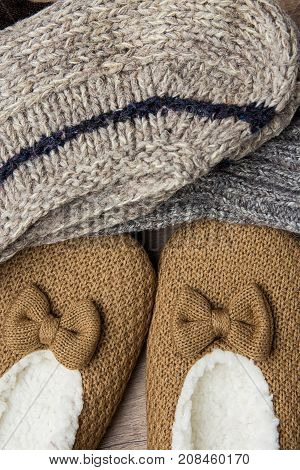 Stack of Handmade Warm Knitted Socks From Rough Wool Yarn Fluffy Fir Slippers Top View. Winter Autumn Eco Fashion Kinfolk Style. Natural Materials.