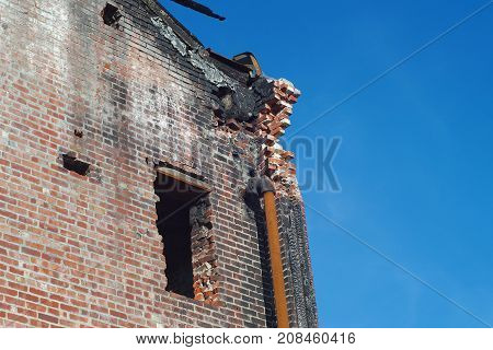 brick building after firer destroyed sinister damaged roof