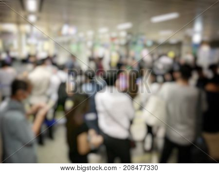 Blurred Image Of Asian People On The Queue Line On Rush Hour Waiting For Train Subway Station. Stay