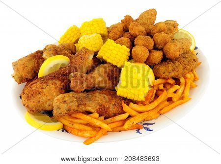 Plate of Southern fried chicken products with sweetcorn and fries