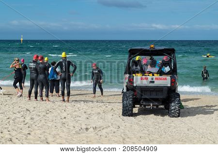Melbourne, Australia - February 11, 2017: surf life savers from Edithvale Life Saving Club, patrolling Edithvale Beach on an off-road vehicle.