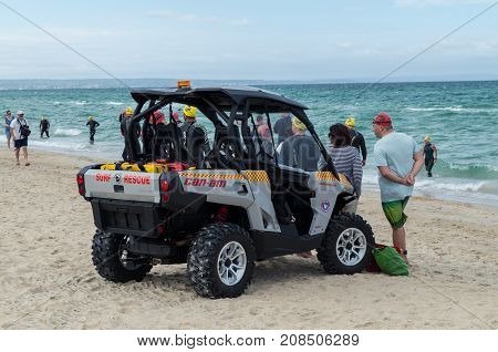 Melbourne, Australia - February 11, 2017: surf life savers from Edithvale Life Saving Club, patrolling Edithvale Beach on an off-road vehicle.