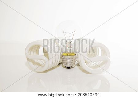 Several different led bulbs and compact fluorescent lamps with the size of the male screw base E27 on a light background