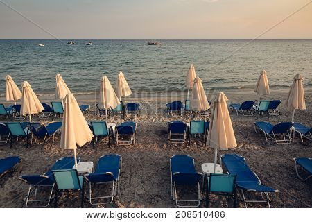 Group of closed beach umrellas by the sea coast